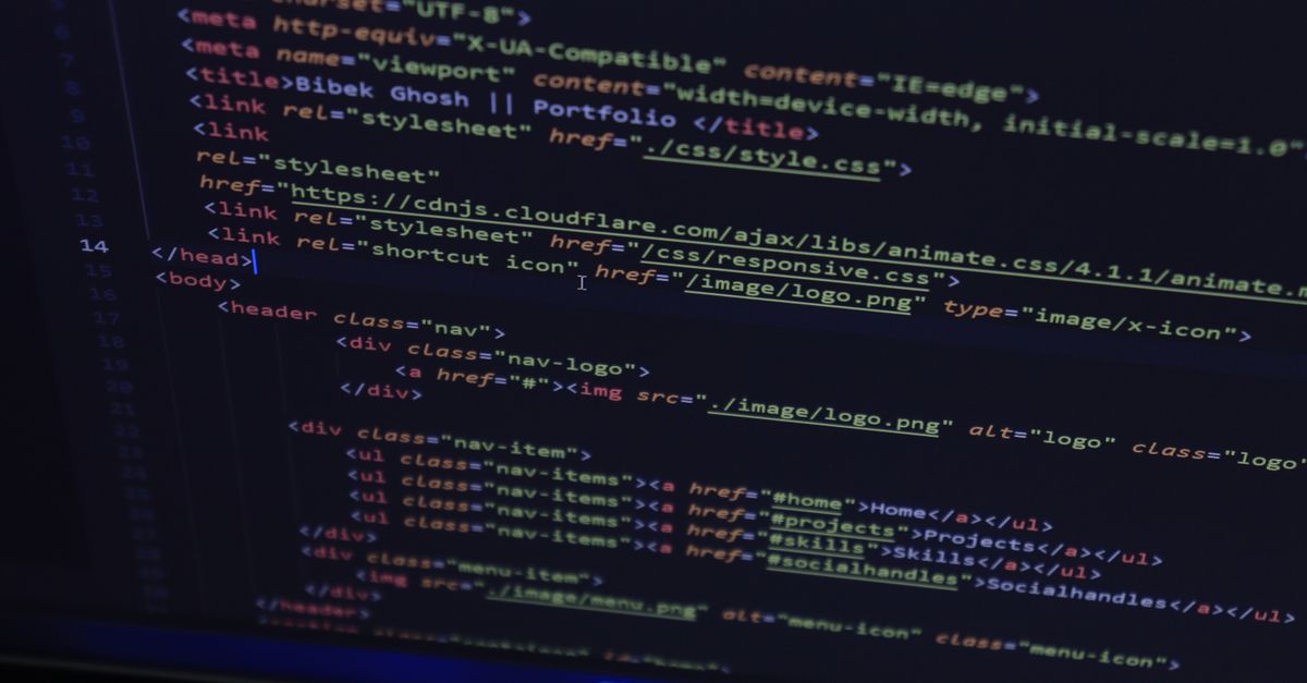 High-resolution close-up of HTML code displayed on a computer screen, perfect for technology themes.